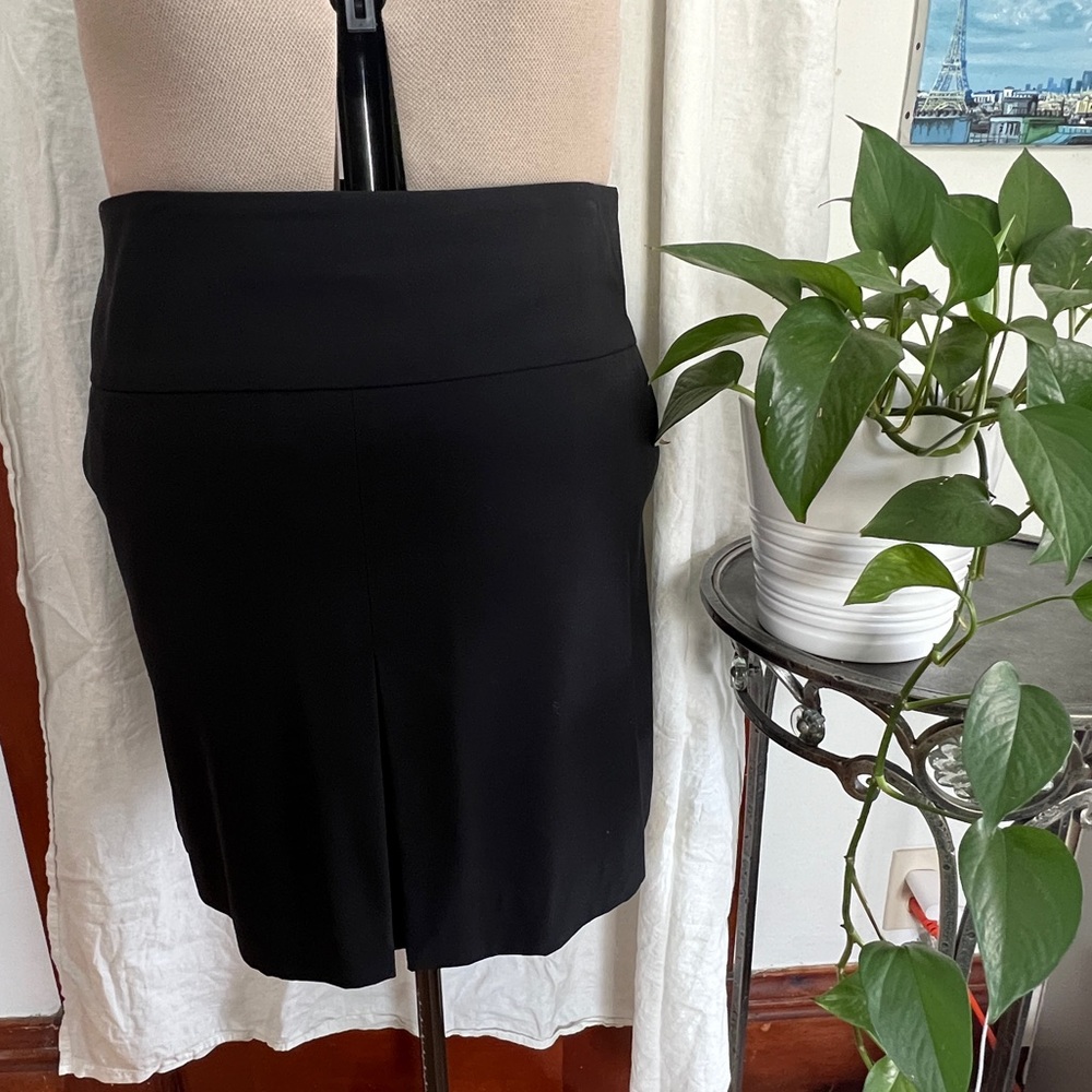 Coach brand short skirt with front pleat, size 12. Like new. Black.